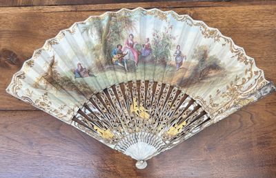 a fan with a painting on it hanging on a wall