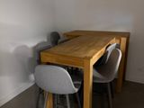 a table and chairs in a room with a window