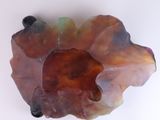 a piece of glass with a bear on it on a white surface