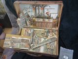 someone is holding a suitcase full of cards and other items