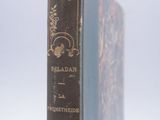 an old book sitting on top of a white surface