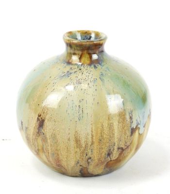 a small vase that is sitting on a white surface