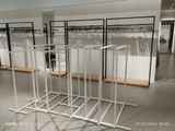 a rack of clothes in the middle of a room