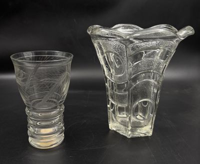 two glass vases sitting next to each other on a table