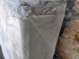 a piece of plastic wrapped around a stone wall