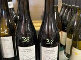 several bottles of wine on a table with a glass top