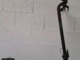 an electric scooter parked against a brick wall in front of a white wall