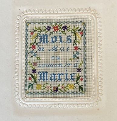 a picture of a cross stitch picture on a white frame