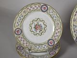 two plates with floral designs are sitting on a table