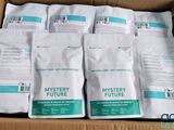six bags of mystery future coffee sit in a cardboard box