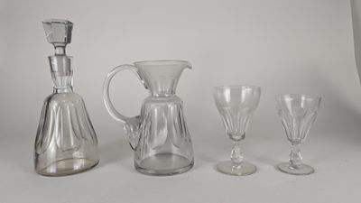 quatre verres à vin et une carafe posés sur une table