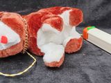 a stuffed animal laying on the ground next to a pen