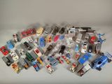 un grand nombre de voitures et de camions jouets qui se trouvent sur la table