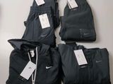 three pairs of black nike pants and a pair of black nike pants