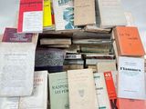 many books stacked on top of each other on a table