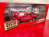 a red toy truck in a box on a red table