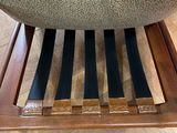 a close up of a wooden chair with a seat made out of wood
