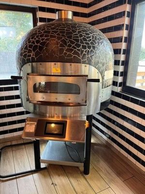 an image of a pizza oven in the corner of a room