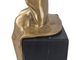 statue of a woman sitting on a black marble block