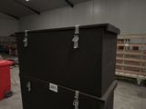 a large black box sitting on top of a cart in a warehouse