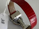 a red leather bracelet with a silver clasp on it