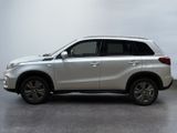 the white suv is parked on the concrete floor in the room