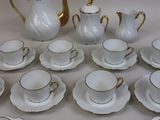 a lot of cups and saucers that are on the table