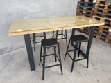 three stools sitting at a table with a glass top
