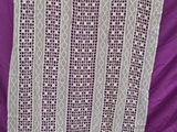 a close up of a purple blanket on a purple cloth