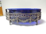a blue glass bowl sitting on top of a table