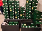 boxes of shoes are stacked on top of each other in a room