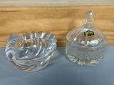 pair of clear glass bowls with lids on a blue surface