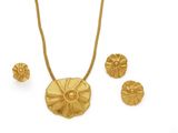 an image of a gold necklace and earring set with a flower design
