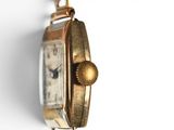 a close up of a watch hanging on a wall