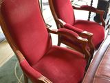 two red chairs sitting next to each other in a room