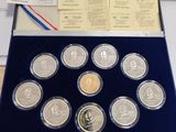 a box of coins sitting on a desk next to a keyboard