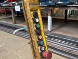 a close up of a remote control on a pole in a warehouse
