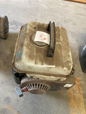 a small lawn mower sitting on the floor next to a wheel
