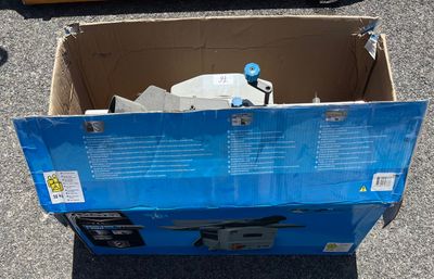 une boîte en carton avec un couvercle bleu posée par terre