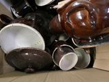 many cups and saucers in a cardboard box
