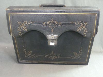a black suitcase with gold trim and a lock