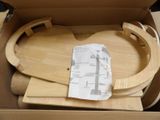 a cardboard box with a wooden train set inside of it