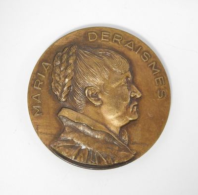 un gros plan sur une médaille de bronze représentant le profil d'une femme