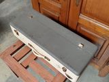 a suitcase that is sitting on the floor in front of a cabinet