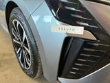 a close up of a car ' s front bumper with a sticker on it