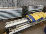 a large pile of metal sheets on a pallet in a warehouse