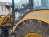 a yellow tractor that is parked in the parking lot