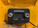 a close up of a clock on the back of a yellow truck