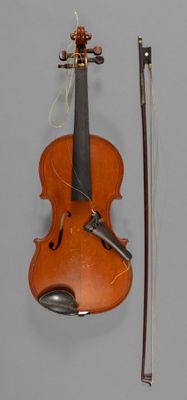 an old violin with a bow and a bow rest on a table