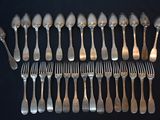 a lot of silver spoons and forks on the table